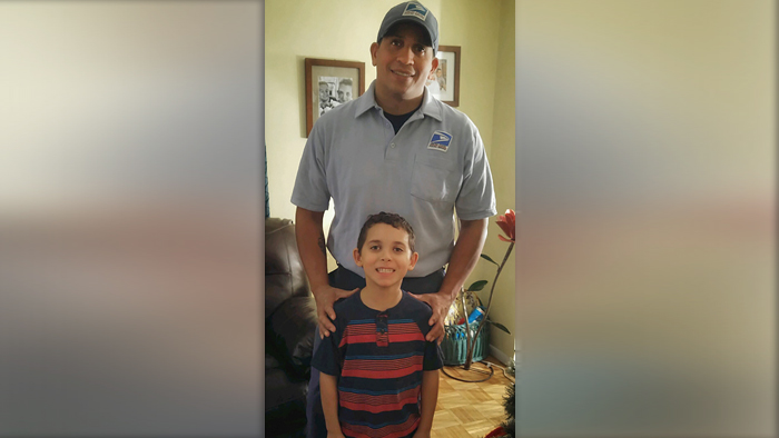 Cleveland Letter Carrier Israel Lopez with his son, Alex