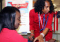 Woman checks other womans blood pressure