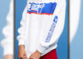 Model wearing white hoodie with USPS logo