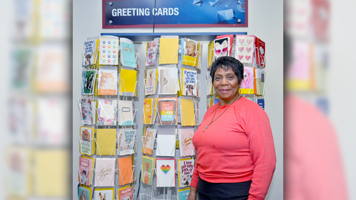 Chicago Mail Handler Bessie Flemons stands near greeting cards