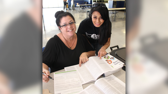 Two CFC campaign workers wearing black CFC T-shirts