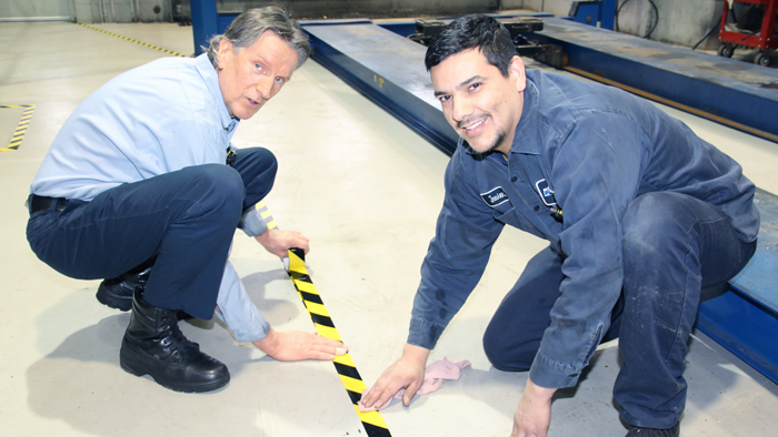 Automotive technicians Janusz Bartola, left, and Javier Rocha lay tape at the Carol Stream, IL, Vehicle Maintenance Facility, which recently got clean and reorganized.