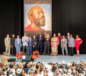 Participants gather on stage after the stamp image is unveiled.