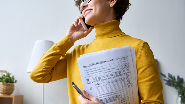 Woman holding tax forms