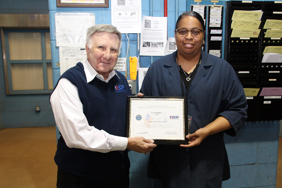 Retired Brig. Gen. John Fascia presents the Patriot Award to Carol Stream, IL, Vehicle Maintenance Facility Supervisor Lisa Walker recently.