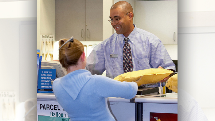 Postal employee serves a customer