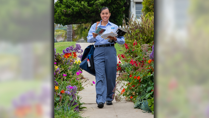 Letter carrier walking on her route