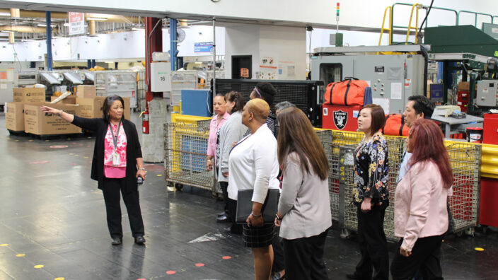 Employees meet at a plant.