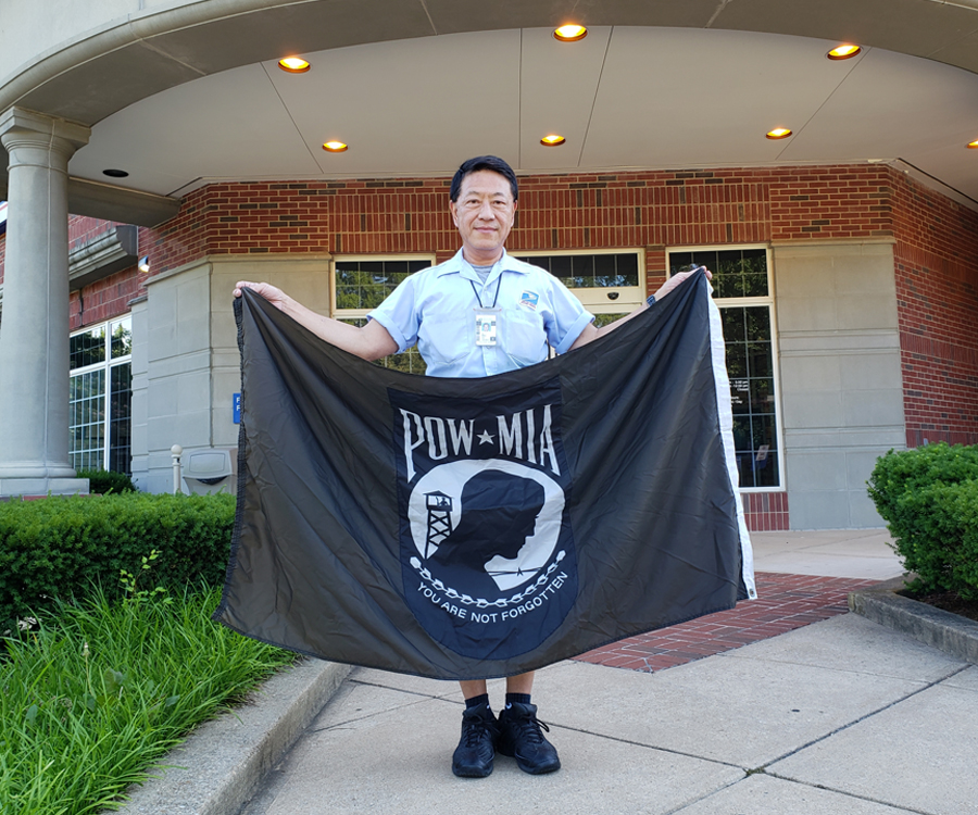Man holding POW flag