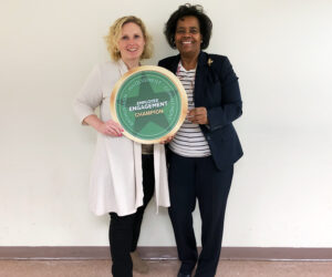 Smiling women hold seal