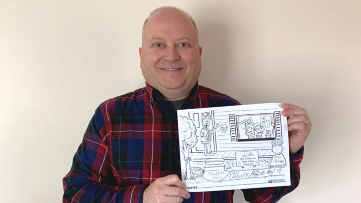 Man holding a drawn cartoon.