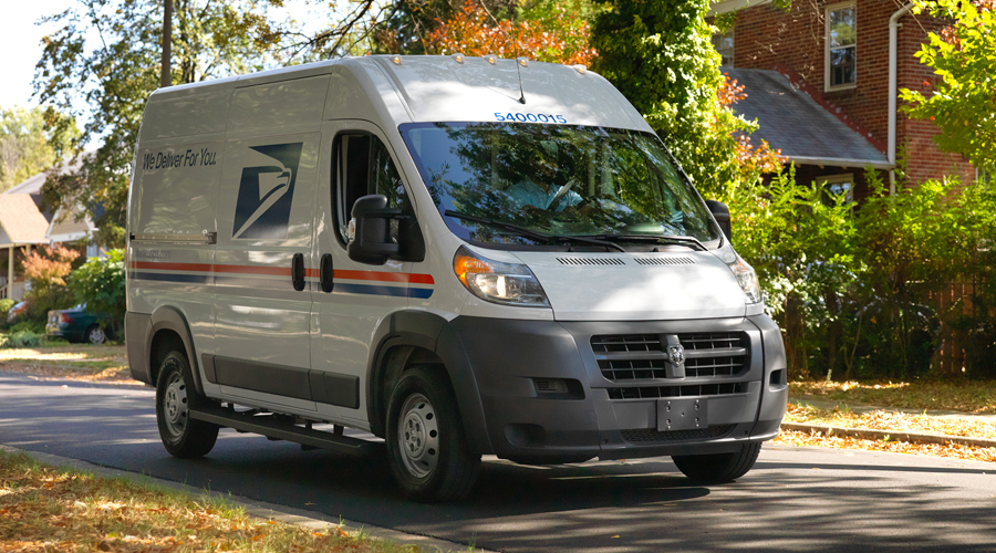 USPS delivery vehicle moves through residential neighborhood