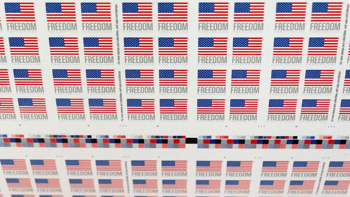 A roll of U.S. Flag stamps being printed