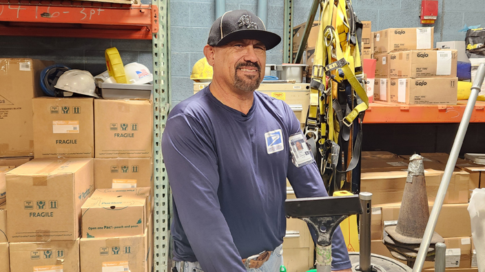 Employee smiling in a workplace storage room