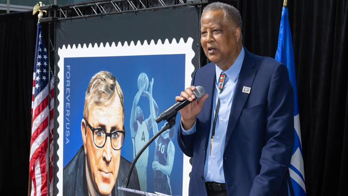 Former basketball player Jamaal “Silk” Wilkes speaks at the John Wooden stamp dedication ceremony.