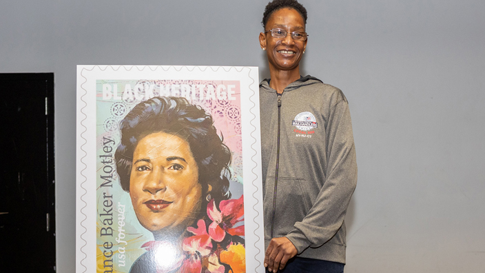 A relative of Constance Baker Motley stands next to the latest stamp release