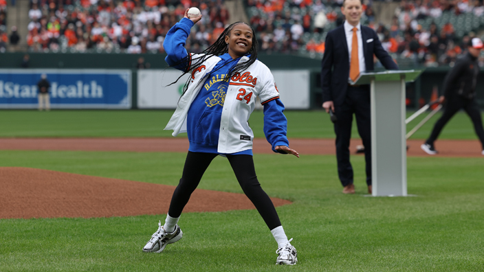 A postal employee's daugther tosses the first pitch on the Baltimore Orioles’ opening day.