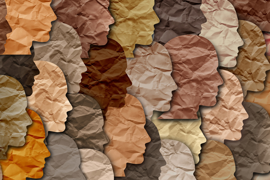 A collage of paper face shapes in several colors