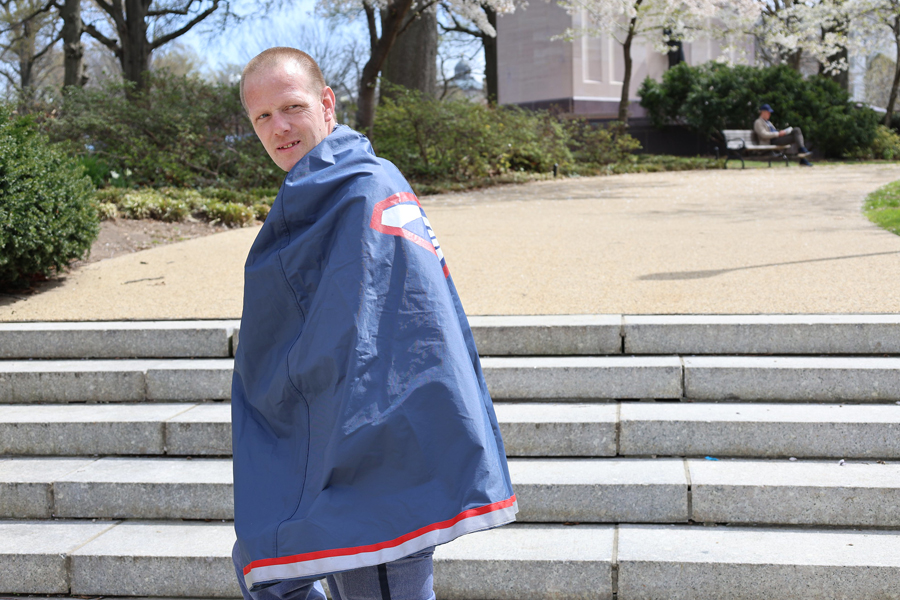 Letter Carrier Timothy Martin wearing a postal-themed cape