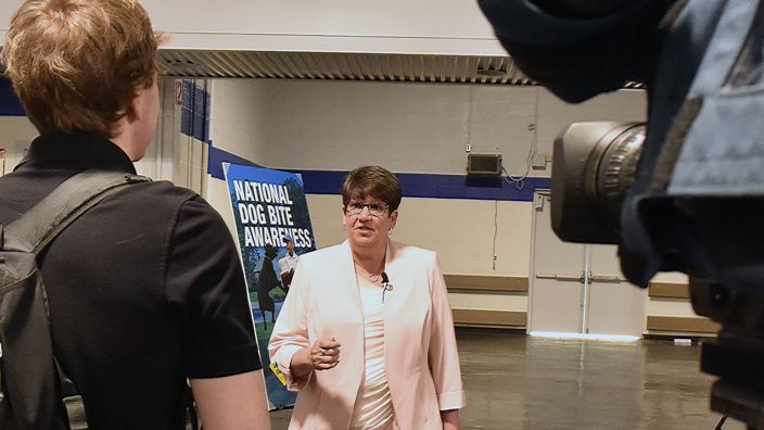Linda DeCarlo, the Postal Service’s occupational safety and health senior director, speaks to a TV news crew at the May 30 news conference.