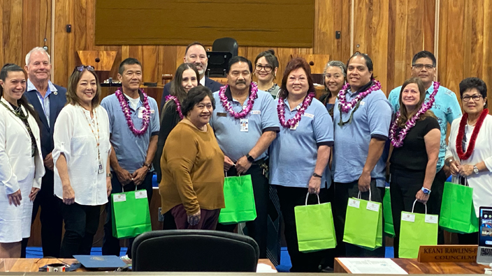 A group of USPS employees gathered in the Maui County Council chamber