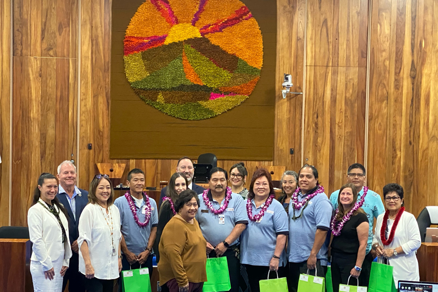 A group of USPS employees gathered in the Maui County Council chamber