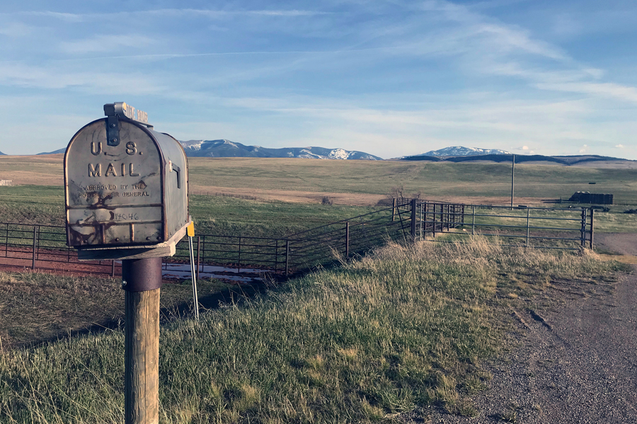 A mailbox on a post in a field
