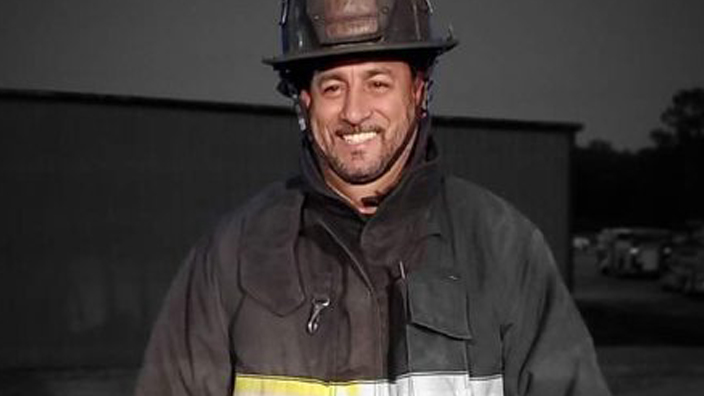 Angel Castro wearing his volunteer firefighter gear