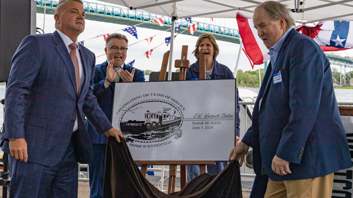 Unveiling the special J.W. Westcott postmark are, from left, Ron Morris, Detroit postmaster; Rick Moreton, Michigan 1 District manager; Carol Glinn, a Royal Oak, MI, letter carrier and district safety committee member; and Jim Hogan, president of the J.W. Westcott Co.