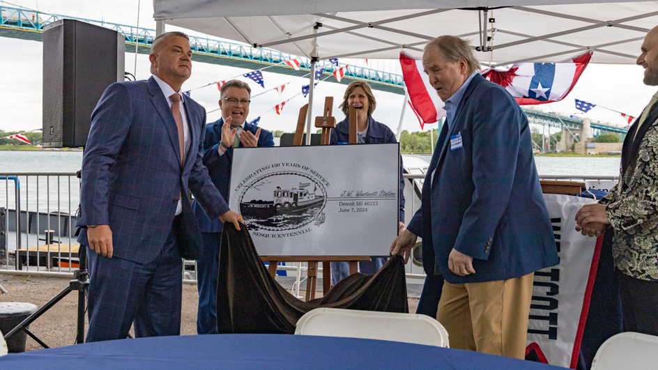 Unveiling the special J.W. Westcott postmark are, from left, Ron Morris, Detroit postmaster; Rick Moreton, Michigan 1 District manager; Carol Glinn, a Royal Oak, MI, letter carrier and district safety committee member; and Jim Hogan, president of the J.W. Westcott Co.
