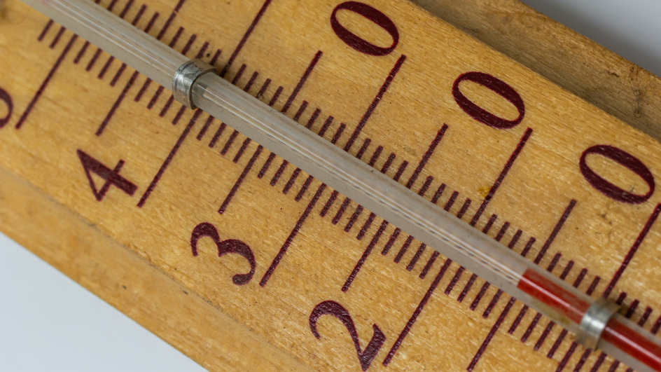 Close-up of numbers on a wooden thermometer