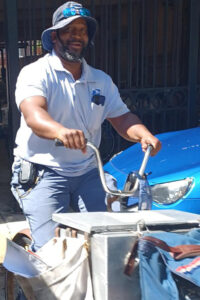 A man on bicycle equipped for carrying mail and packages