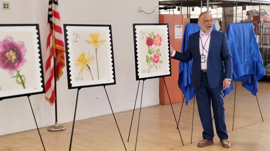 Mario Harris, Post Office operations manager for California 2 District, unveils the stamp images at the Berkeley, CA, Post Office.