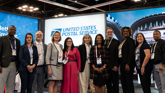 Kevin McIndoe, from left, operations senior director for the Postal Corp. of Jamaica; Ingrid Arias Vargas, IT manager, and Mauricio Rojas, general manager, of Correos de Costa Rica; Judy de Torok, USPS corporate affairs vice president; Julia Pavlenko, international operations director for the Ukrainian postal service; Wendy Eitan, e-commerce physical services integration director for the Universal Postal Union; Joy Doby, USPS international postal affairs specialist; Chris Lien, chairman, National Postal Forum Board of Directors; Sophia Hamilton-Brown, deputy postmaster general of Jamaica’s Post and Telecommunications Dept.; Modi Delgado, USPS international postal affairs specialist; and Jhomo Marshall, facilities manager for Jamaica’s Post and Telecommunications Dept.