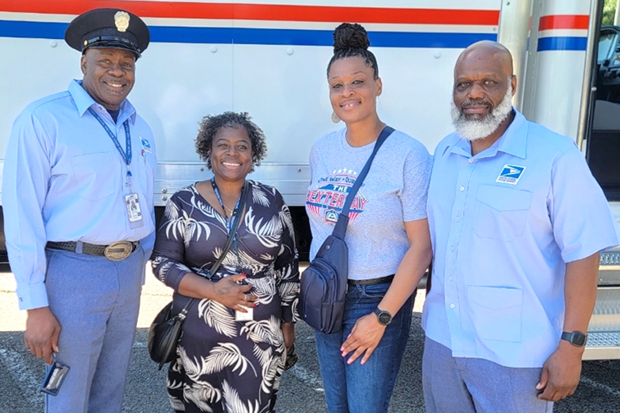 USPS employees Willie Relliford, LaTonya Bryant and Glenn Sisco stand with Julie Cole, second from right, a counselor at the Covington, TN, school they recently visited.