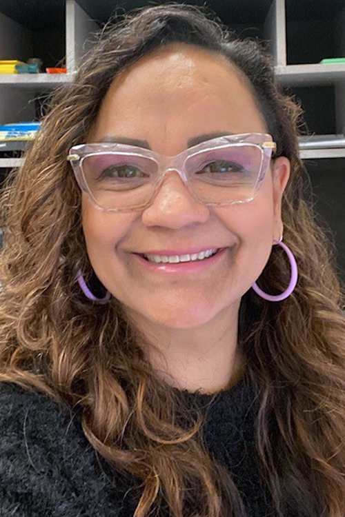 Smiling woman in postal workroom