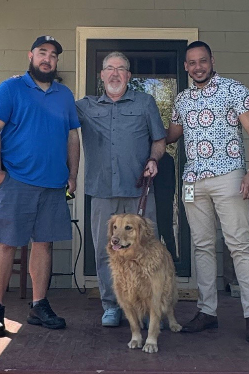 Springfield, MA, City Carrier Assistant Joseph Morales Caraballo, left, with homeowner Steve Cary and Juan Cabrera, the local acting station manager.