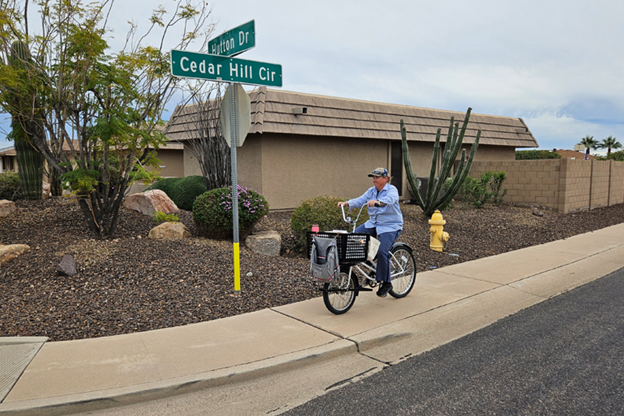 Kelly Fischer, a Sun City, AZ, letter carrier, rides a bike along her route.