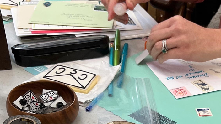 A stamped letter getting decorated