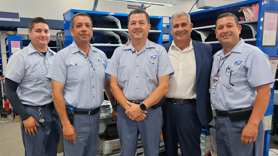 The Penas stand inside a workroom at the Chula Vista, CA, Post Office. From left are David J., Saul, David E., David F. and Helaman.