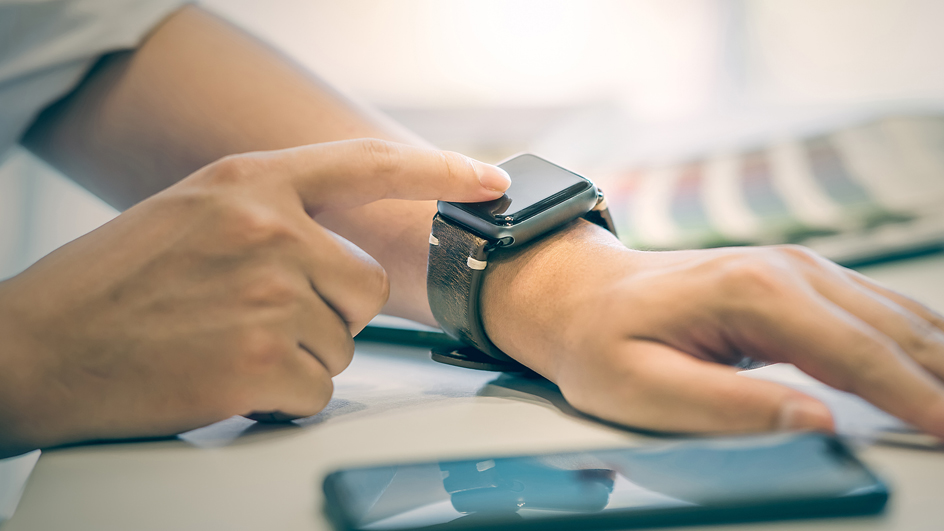 A user looks at a smartwatch