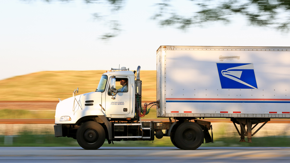 USPS-branded tractor-trailer on highway