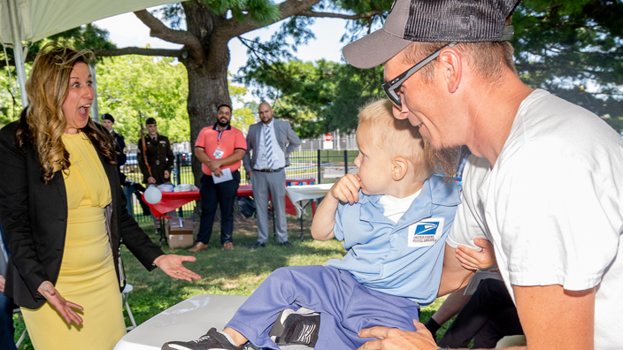 Hartford, CT, Postmaster Tricia Lucas is surprised to see nephews Parker and Joey at her installation ceremony.