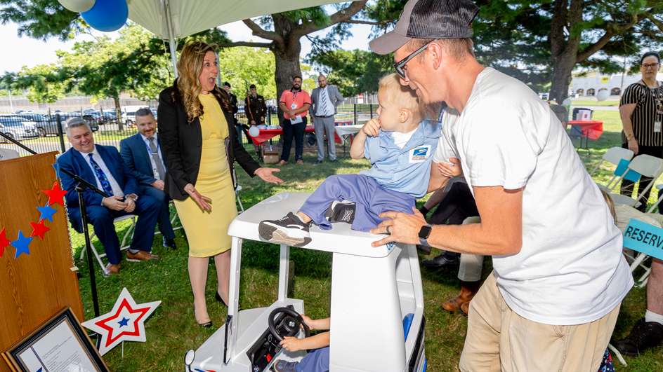 Hartford, CT, Postmaster Tricia Lucas is surprised to see nephews Parker and Joey at her installation ceremony.