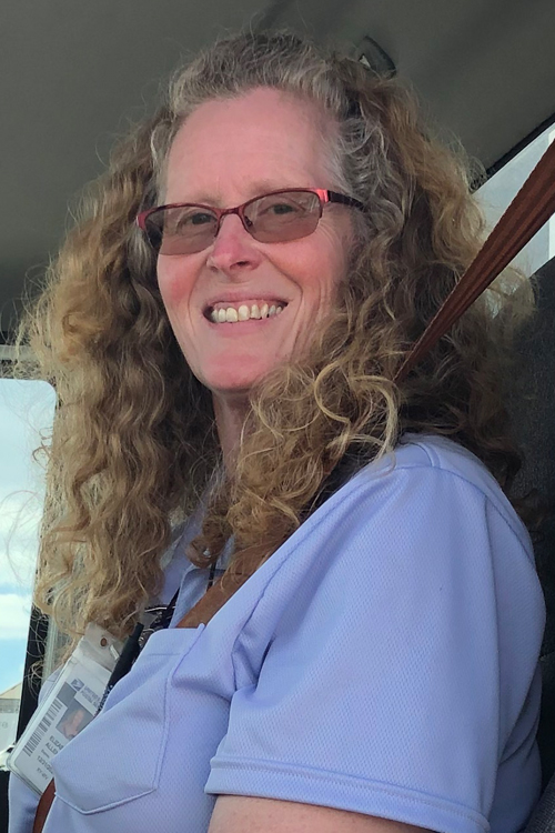 Beth Allen sits in the cab of the tractor trailer she operates out of Lexington, KY.