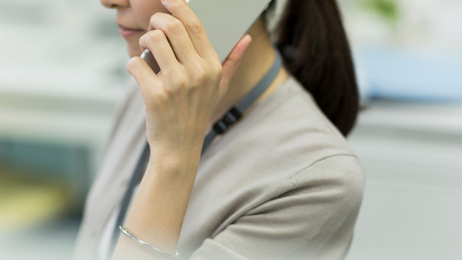 A woman holding a smartphone to her ear.