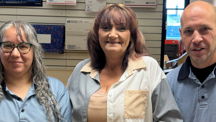 Retail Associate Dorothy Orr, left, Postmaster Jacquetta Hahn-Weisz and Retail Associate Thomas Jergensen stand behind the retail counter at the Liberty, IN, Post Office.