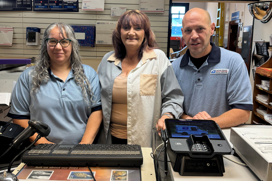 Retail Associate Dorothy Orr, left, Postmaster Jacquetta Hahn-Weisz and Retail Associate Thomas Jergensen stand behind the retail counter at the Liberty, IN, Post Office.