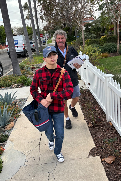 San Diego Letter Carrier Gaylend “Zee” Zahn delivers mail recently with help from his friend, Roman Toriello.