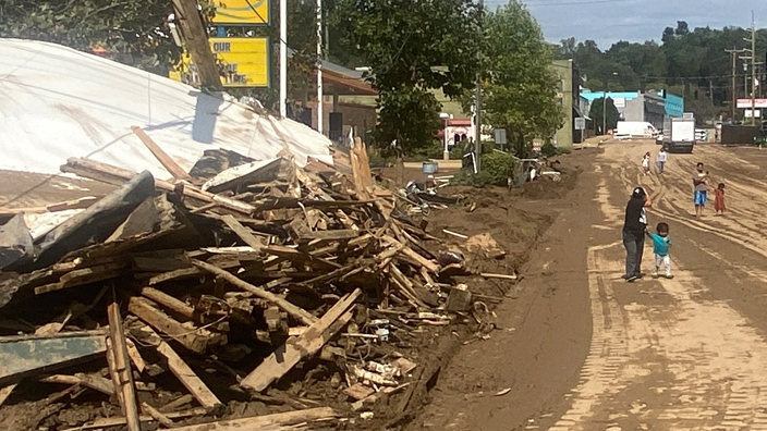 A street with debris pile on the left side.